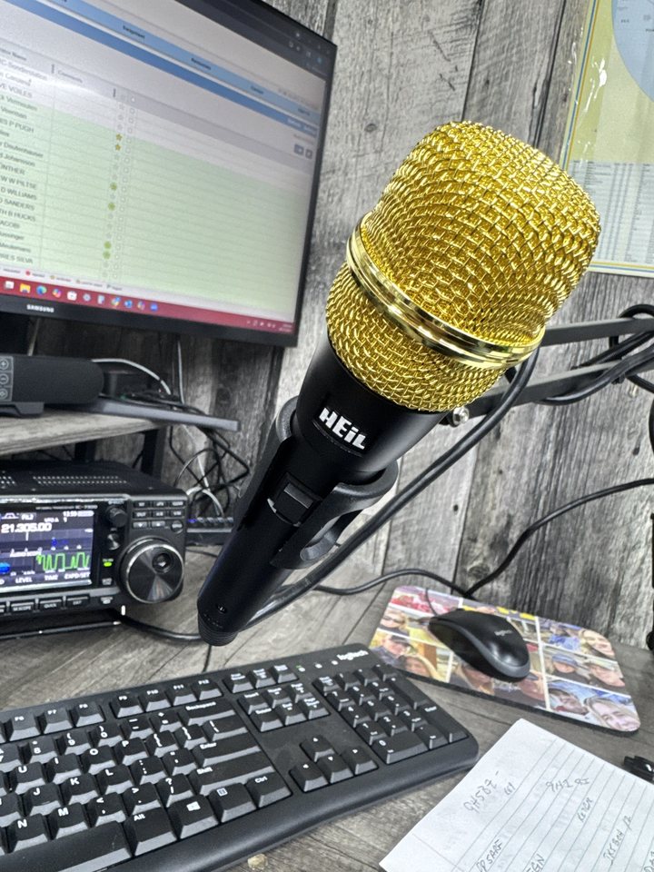 Ham radio shack with an Icom IC-7300 transceiver, Heil microphone and contest logging software
